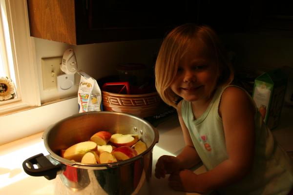 Ruby posing next to her apples.